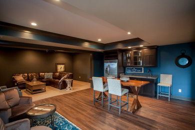 Photo of a large rustic open plan games room in Orange County with carpet, a standard fireplace, a tiled fireplace surround, a wall mounted tv and multi-coloured walls.