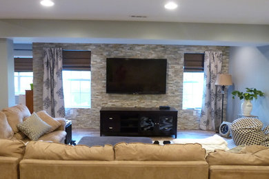 Family room - large contemporary open concept medium tone wood floor family room idea in Philadelphia with gray walls and a wall-mounted tv