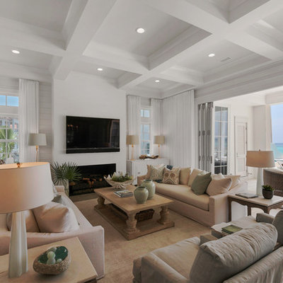 Huge beach style open concept light wood floor family room photo in Miami with white walls, a wall-mounted tv, a standard fireplace and a tile fireplace