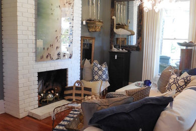 Example of a mid-sized beach style enclosed medium tone wood floor family room design in Atlanta with gray walls, a standard fireplace and a brick fireplace