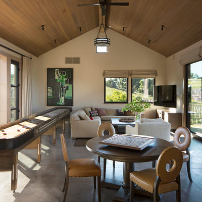 Transitional concrete floor game room photo in San Francisco with beige walls
