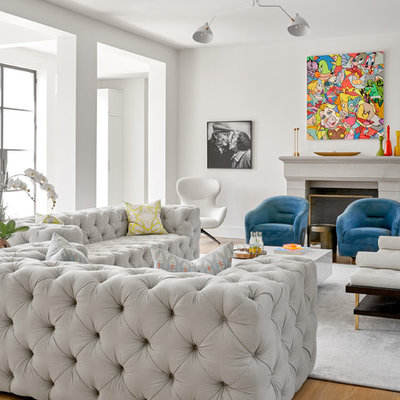 Example of a mid-sized transitional open concept brown floor and medium tone wood floor family room design in Dallas with white walls, a standard fireplace, a concrete fireplace and no tv