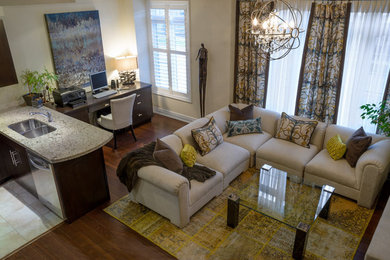 Example of a trendy medium tone wood floor family room design in Toronto with beige walls, a ribbon fireplace, a brick fireplace and a wall-mounted tv