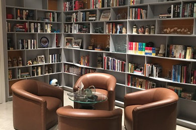 Large trendy enclosed family room library photo in Los Angeles with gray walls and a wall-mounted tv