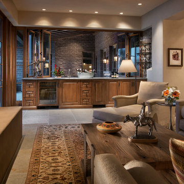 Bifold windows over an indoor-outdoor bar open up this family room to the patio