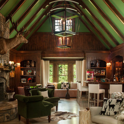 Inspiration for a rustic open concept family room remodel in Miami with green walls, a standard fireplace and a stone fireplace