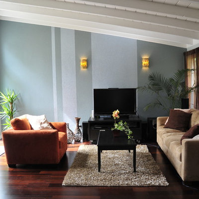 Example of a trendy dark wood floor family room design in San Francisco with blue walls