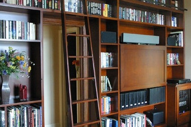 Inspiration for a huge timeless open concept family room library remodel in Los Angeles with a media wall