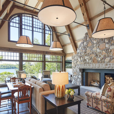 Large mountain style open concept medium tone wood floor and brown floor family room photo in Minneapolis with a standard fireplace, beige walls, a stone fireplace and no tv