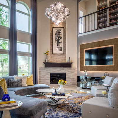 Huge transitional open concept porcelain tile and beige floor family room photo in Houston with gray walls, a corner fireplace, a tile fireplace and a wall-mounted tv