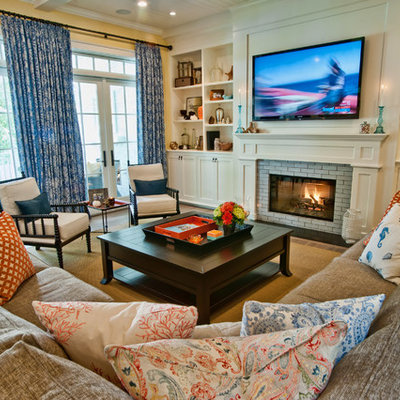 Example of a classic family room design in Los Angeles with yellow walls, a standard fireplace and a media wall