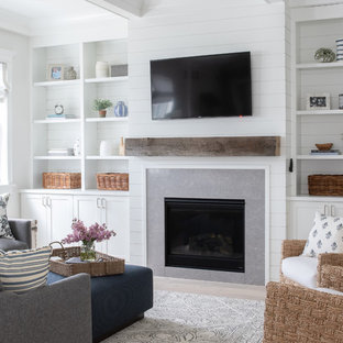 Family room - large cottage enclosed light wood floor and beige floor family room idea in Chicago with white walls, a standard fireplace, a tile fireplace and a wall-mounted tv