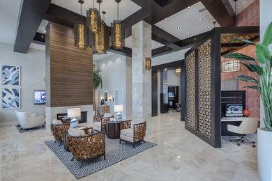 Example of a huge transitional open concept ceramic tile family room design in Miami with a two-sided fireplace and a stone fireplace