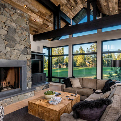 Inspiration for a rustic light wood floor family room remodel in Other with white walls, a standard fireplace, a metal fireplace and a media wall