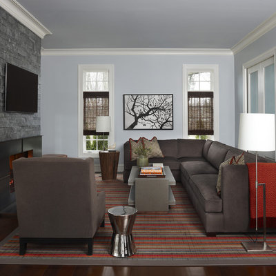 Mid-sized trendy enclosed dark wood floor and brown floor family room photo in Detroit with a standard fireplace, a metal fireplace, a wall-mounted tv and blue walls