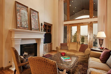 Example of a mid-sized classic open concept light wood floor family room design in Denver with white walls, a standard fireplace, a plaster fireplace and a tv stand