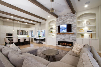 Example of a transitional light wood floor family room design in Phoenix with a stone fireplace