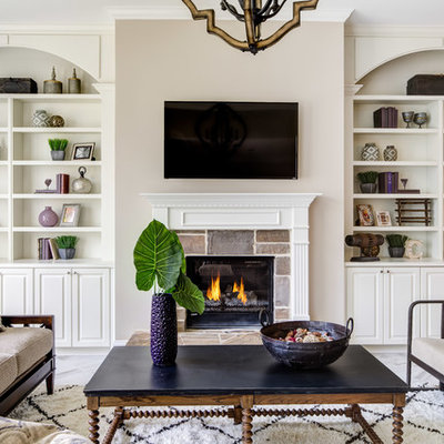 Family room - traditional family room idea in Atlanta with beige walls, a standard fireplace, a stone fireplace and a wall-mounted tv