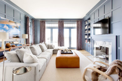 Family room - large contemporary open concept light wood floor and beige floor family room idea in New York with blue walls, a standard fireplace, a tile fireplace and a wall-mounted tv