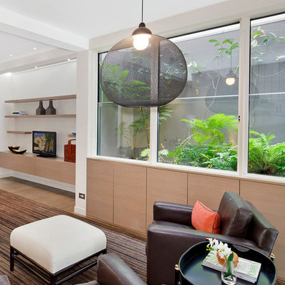 Inspiration for a contemporary open concept family room remodel in Sydney with white walls