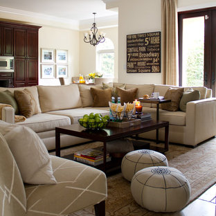 Family room - large traditional open concept travertine floor family room idea in Los Angeles with beige walls and no fireplace