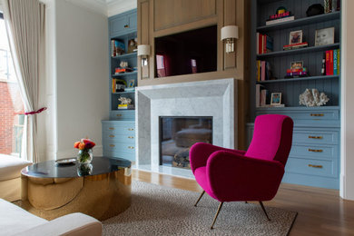 Example of a mid-sized beach style open concept medium tone wood floor and brown floor family room library design in Chicago with blue walls, a standard fireplace, a stone fireplace and a media wall