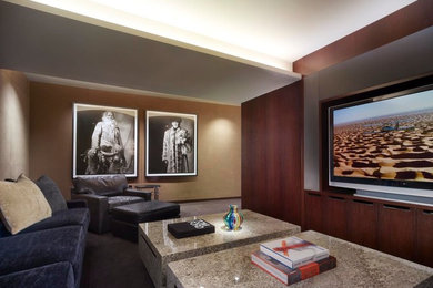 Example of a mid-sized trendy enclosed carpeted home theater design in Los Angeles with brown walls and a wall-mounted tv