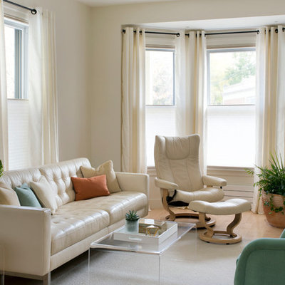 Family room - mid-sized transitional enclosed light wood floor and beige floor family room idea in Boston with beige walls, no fireplace and a wall-mounted tv