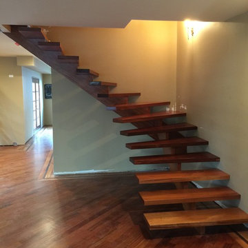 Cantilevered, radiused, mahogany staircase