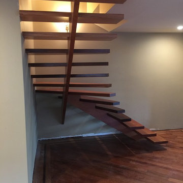 Cantilevered, radiused, mahogany staircase