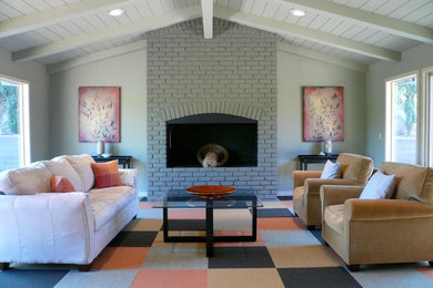 Example of a trendy carpeted and multicolored floor family room design in San Francisco with a standard fireplace and a brick fireplace
