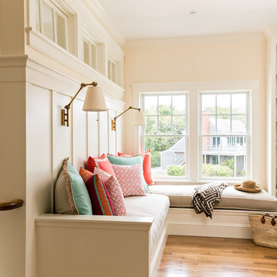 Small elegant loft-style medium tone wood floor and brown floor family room photo in Boston with beige walls, no fireplace and no tv