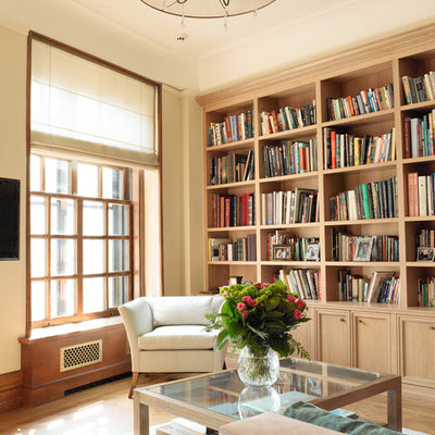 Inspiration for a mid-sized transitional open concept medium tone wood floor family room library remodel in New York with beige walls, no fireplace and a wall-mounted tv