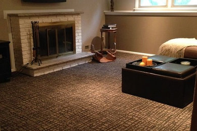 Family room - mid-sized transitional enclosed carpeted family room idea in Orange County with beige walls, a standard fireplace, a brick fireplace and a wall-mounted tv