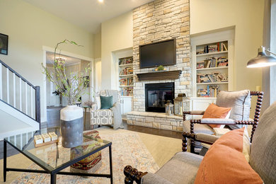 Family room - transitional open concept dark wood floor and brown floor family room idea in Cincinnati with gray walls, a standard fireplace, a stone fireplace and a wall-mounted tv