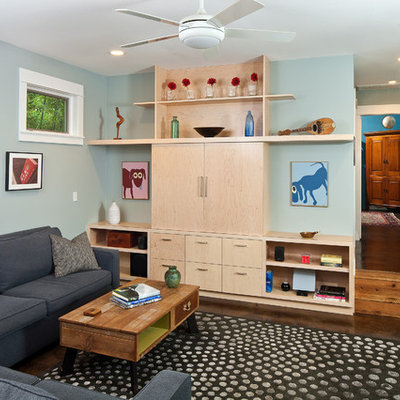 Inspiration for a small contemporary open concept concrete floor family room remodel in Austin with blue walls and a media wall