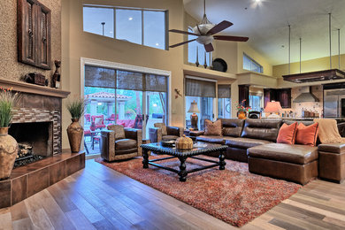 Expansive classic open plan games room in Phoenix with beige walls, light hardwood flooring, a corner fireplace and a tiled fireplace surround.