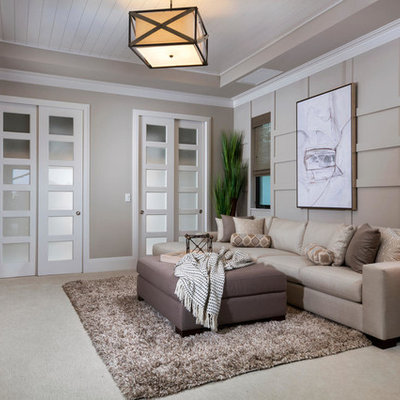 Example of a mid-sized transitional enclosed carpeted and beige floor family room design in Other with no fireplace, a wall-mounted tv and gray walls