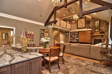 Example of a large transitional open concept gray floor family room design in Other with gray walls, a corner fireplace, a stone fireplace and a media wall