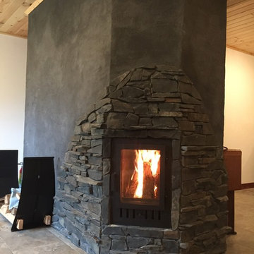 Charcoal plaster and slate masonry heater/fireplace