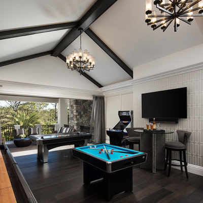 Example of a classic dark wood floor and brown floor game room design in Miami with multicolored walls, no fireplace and a wall-mounted tv