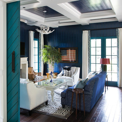 Family room - eclectic enclosed dark wood floor and brown floor family room idea in Denver with blue walls, a standard fireplace and a media wall