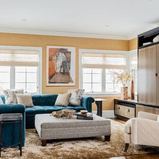 Large transitional open concept brown floor and dark wood floor family room photo in Boston with no fireplace, a concealed tv and yellow walls