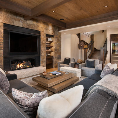Inspiration for a huge rustic open concept light wood floor family room remodel in Denver with beige walls, a metal fireplace, a wall-mounted tv, a bar and a ribbon fireplace