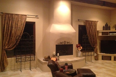 Tuscan family room photo in Other with a standard fireplace and a plaster fireplace