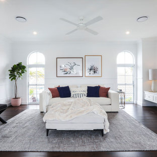 Inspiration for a beach style family room in Gold Coast - Tweed with white walls, dark hardwood floors, a freestanding tv and brown floor.