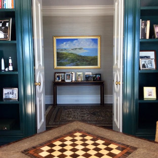 Inspiration for a large timeless enclosed dark wood floor family room library remodel in New York with no fireplace and blue walls
