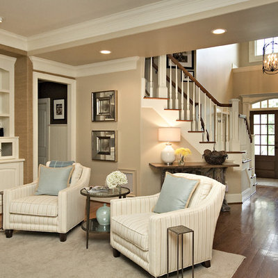 Family room - traditional dark wood floor family room idea in Raleigh with beige walls