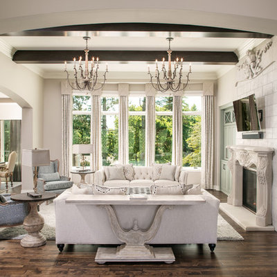 Tuscan dark wood floor and brown floor family room photo in Omaha with gray walls and a standard fireplace