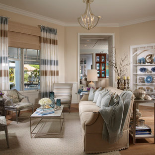 Island style medium tone wood floor family room photo in Tampa with beige walls and no tv